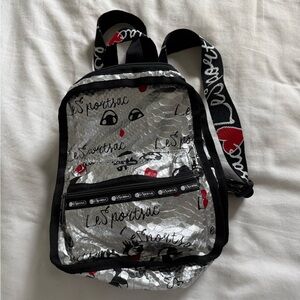 LeSportsac Metallic Silver Backpack with Black and Red Accents